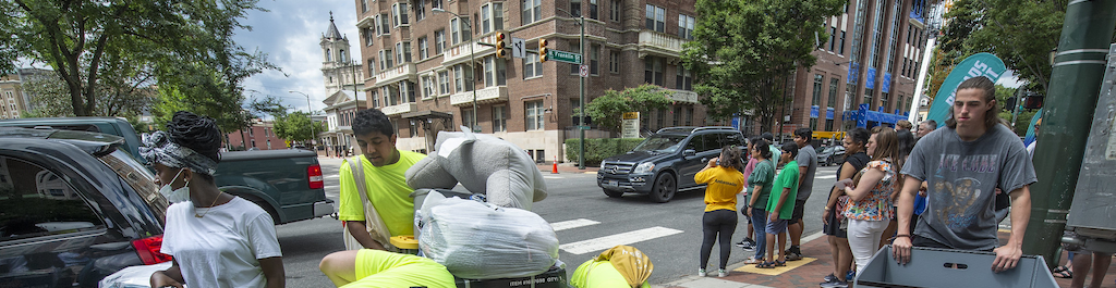 families and volunteers with move-in carts